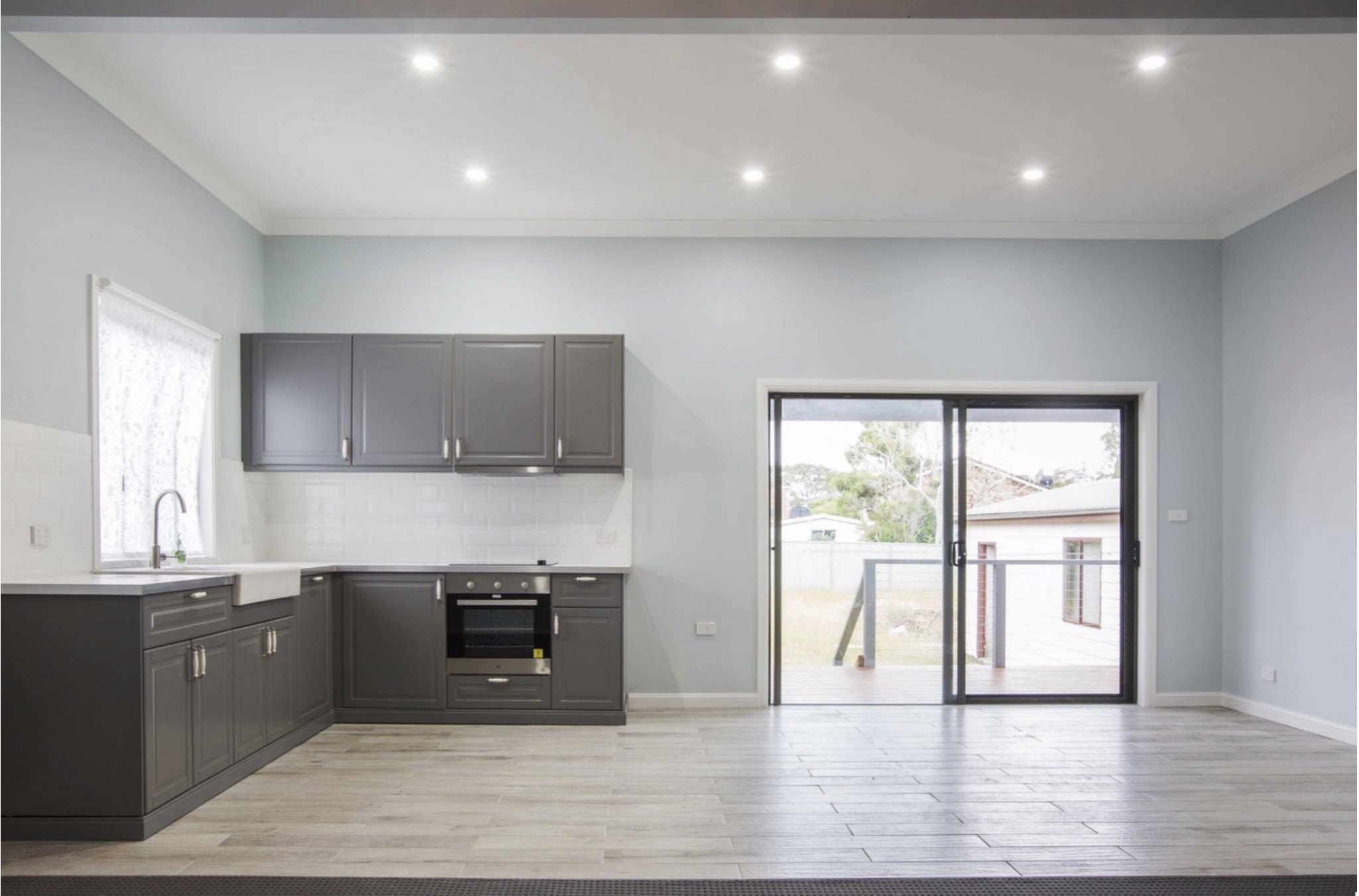 Kitchen with charcoal cabinets and pale grey walls